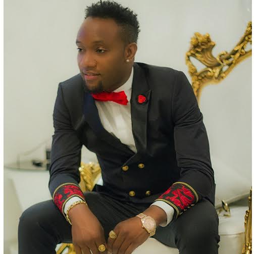 KCee Lights Up In Blue-Red Birthday Photo
